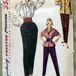 May include: Vintage Simplicity pattern 4464 featuring illustrations of women's clothing designs. The cover shows three outfits: a blouse with ruffles, high-waisted pants, a jacket with plaid pants, and a short-sleeved blouse with pants. The pattern is size 12, bust 30.