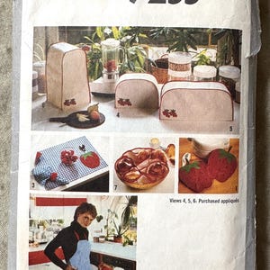 May include: Simplicity pattern 9255, featuring various kitchen accessories with a strawberry theme. Includes covers for appliances, an apron, and appliqués. The pattern is one size.