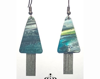 May include: A pair of triangle-shaped earrings with a blue, green, and gray abstract design. The earrings have a silver bar hanging from the bottom.