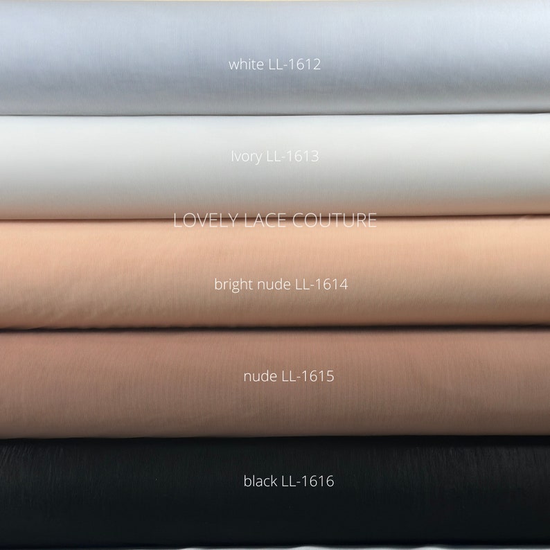 May include: Five rolls of tulle fabric in different colors: white, ivory, bright nude, nude, and black. Each roll has a label with the color name and a code, for example, "white LL-1612". The label "LOVELY LACE COUTURE" is visible on the third roll.