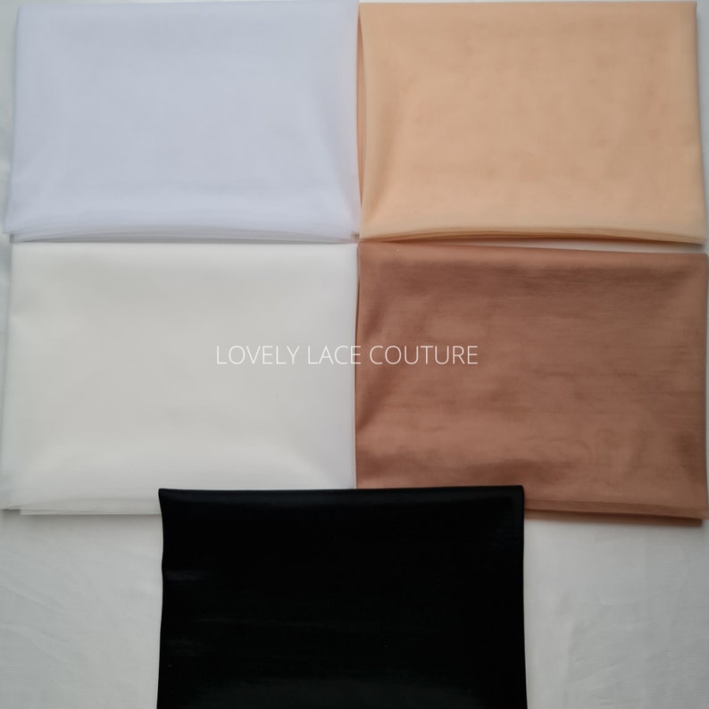 May include: Four swatches of sheer fabric in white, light brown, dark brown, and black. The swatches are laid out on a white surface. The text "LOVELY LACE COUTURE" is printed in the center of the image.