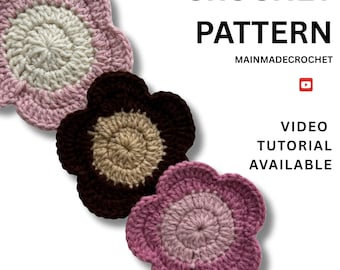 May include: Three handmade crochet flower patterns in shades of pink, brown, and cream. The flowers have a layered design with a scalloped edge. Text on the image reads "CROCHET PATTERN" and "VIDEO TUTORIAL AVAILABLE".