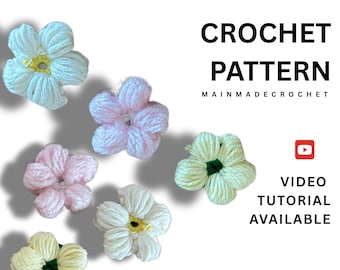 May include: A collection of handmade crochet flowers in various pastel colors, including light blue, pink, and yellow. The image also includes the text "CROCHET PATTERN" and "VIDEO TUTORIAL AVAILABLE."