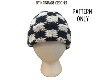 May include: A navy blue and white checkered beanie, displayed on a mannequin head. The text on the image reads "CHECKERED BEANIE INSTANT DOWNLOAD BY MAINMADE CROCHET" and "PATTERN ONLY". There is a YouTube logo with the text "FOLLOW ALONG WITH THE VIDEO TUTORIAL".