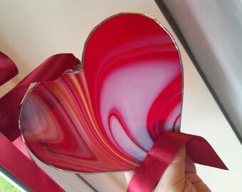 Beautiful deep red strawberry and cream glass heart Hung by a satin ribbon and 17cm width can be supplied on a matching chain