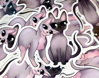 以下が含まれることがあります： 大きな目をした漫画の猫が描かれたカラフルなステッカーのセット。ステッカーは白い紙に印刷されており、光沢のある仕上げになっています。