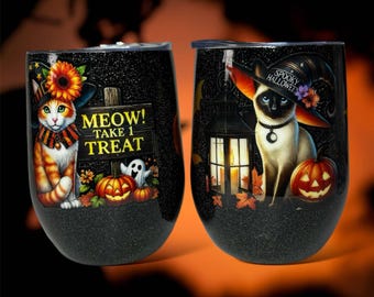 May include: Two black and glitter Halloween themed stainless steel tumblers. One features a cat wearing a witch hat with the text "Meow! Take 1 Treat". The other features a cat wearing a witch hat with the text "Spooky Halloween".
