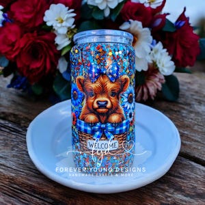 Patriotic Highland Cow Glass Can | Snow Globe Tumbler | Glitter Cold Cup | 16oz Glass Cup with Straw | Highland Cow Gift | Ready to Ship
