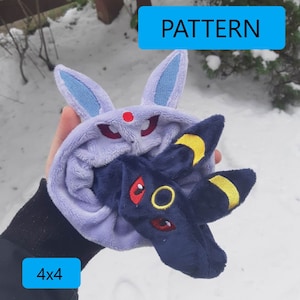 May include: A purple and blue plush toy with the text "PATTERN" and "4x4" on the image. The toy is shaped like a Pokemon character with large ears and a crescent moon on its head.