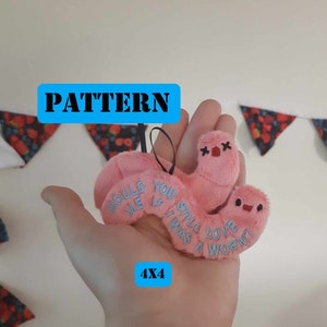 May include: Pink plush worm with embroidered text "Would you love me if I was a worm?" and a 4x4 pattern.