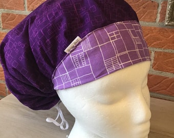 PURPLE PASSION BOUFFANT Scrub/Hat Background is Dark Purple with Lighter violet dots.  Band is a pastel purple with white abstract boxes