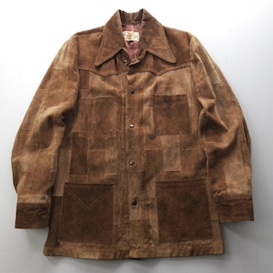 May include: A brown suede jacket with a patchwork design. The jacket has a button-up front, long sleeves, and two large pockets on the front.