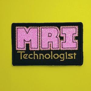 May include: Black embroidered patch with pink glitter letters spelling "MRI" and the text "Technologist" in gold thread.
