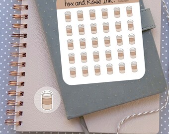 Peut inclure: Une feuille d'autocollants représentant 36 tasses de café illustrées avec un design brun et blanc. Les autocollants sont disposés en grille. La feuille est intitulée "Fox and Roe Ink. Coffee To Go".