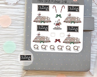 May include: A set of 10 printable stickers featuring a hot chocolate bar theme. The stickers include a variety of designs, such as mugs of hot chocolate with marshmallows, candy canes, and a sign that says "Hot Chocolate Bar".