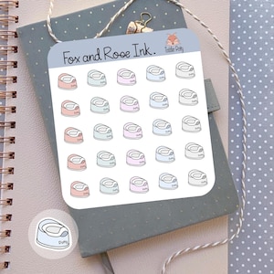 May include: A sheet of stickers featuring potty training potties in various pastel colors: pink, blue, and mint green. The stickers are arranged on a light blue background. The text "Fox and Rose Ink." and "Toddler Pretty" is visible.
