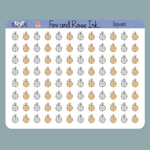 May include: A sticker sheet with a grid of stopwatch designs in silver and gold. The text "XL DeLuxe", "Fox and Rose Ink.", and "Stopwatch" are printed on the sheet. The stopwatches are a mix of silver and gold.