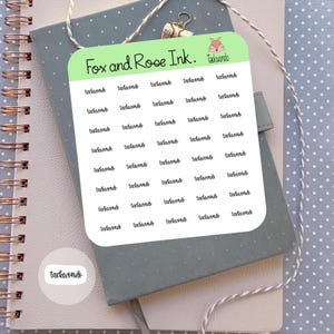 May include: A sheet of white sticker paper with the words "Fox and Rose Ink. Tackwondo" printed at the top. The sheet is filled with 36 individual stickers, each with the word "tackwondo" written in black cursive.
