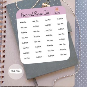 May include: A sheet of stickers with the text "Meal Plan" repeated multiple times. The stickers are on a light pink background with a fox illustration and the text "Fox and Rose Ink." at the top.