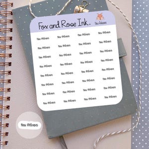 May include: A sheet of stickers with the text "New Releases" repeated 24 times. The stickers are on a light blue background with a fox illustration in the top right corner. The text "Fox and Rose Ink." is at the top of the sheet.