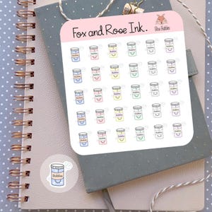 May include: A sheet of stickers featuring various colored jars with the word "Bubbles" written on them. The stickers are arranged in a grid pattern and are labeled "Fox and Rose Ink. Blow Bubbles".
