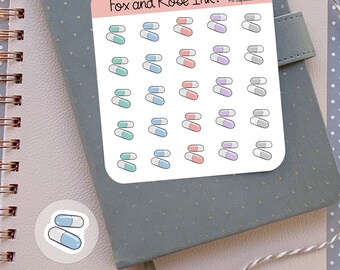 May include: A sheet of stickers with various colored pill capsule illustrations. The stickers are on a white background with the text "Fox and Rose Ink. Pill Capsules".