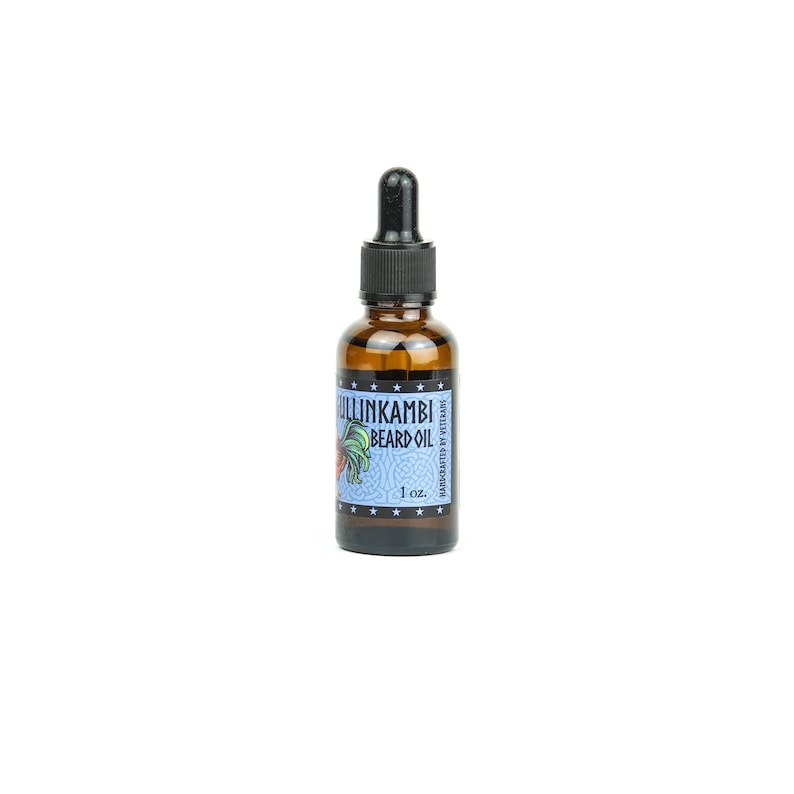 May include: A brown glass bottle with a black dropper top. The bottle is labeled "ULLINKAMBI BEARD OIL" with a rooster illustration and the text "MOISTURIZE & STRENGTHEN" in a blue and white design. The bottle contains 1 oz. of beard oil.