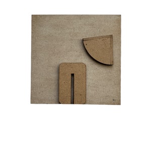 May include: A light brown wooden board with two geometric shapes cut out of it. The shapes are a rectangle with a vertical slit in the middle and a quarter circle.