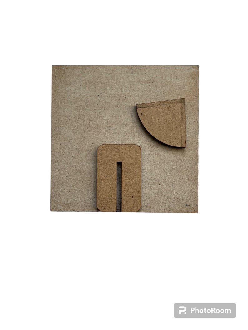 May include: A light brown wooden board with two geometric shapes cut out of it. The shapes are a rectangle with a vertical slit in the middle and a quarter circle.