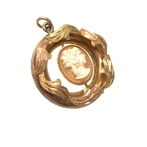 vintage gold cameo pendant with gold leaf design.