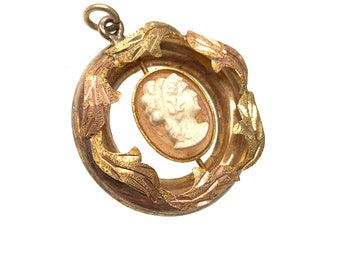 vintage gold cameo pendant with gold leaf design.