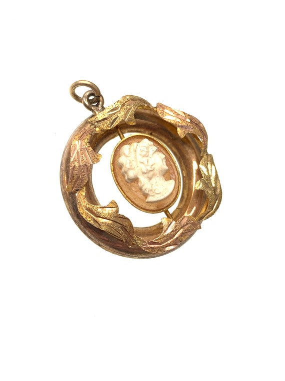vintage gold cameo pendant with gold leaf design.