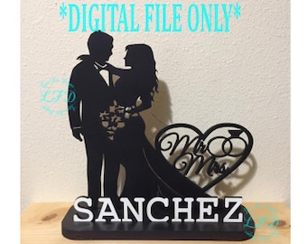 May include: Black silhouette of a couple holding hands with a heart shape behind them that says "Mr & Mrs" and the last name "SANCHEZ" below.