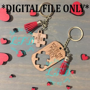 Puede incluir: Dos llaveros de madera con forma de pieza de rompecabezas con borlas rojas. El primer llavero dice "You Complete Me" y el segundo llavero dice "You're My Missing Piece".