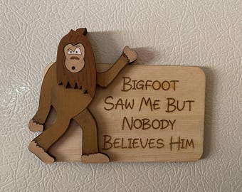 May include: A wooden sign with a cartoon Bigfoot figure attached. The sign reads "Bigfoot Saw Me But Nobody Believes Him".