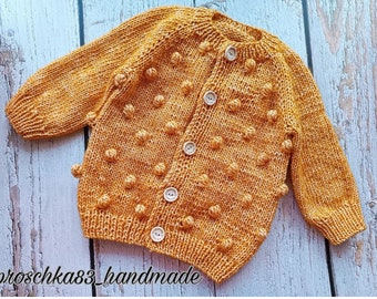 Cardigan for girls with manual knitting.