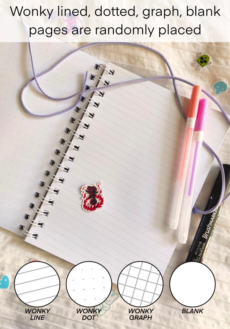 May include: Open notebook with spiral binding, featuring lined, dotted, graph, and blank pages. The text "Wonky lined, dotted, graph, blank pages are randomly placed" is visible. Includes pens and decorative stickers. The notebook has a variety of page styles.