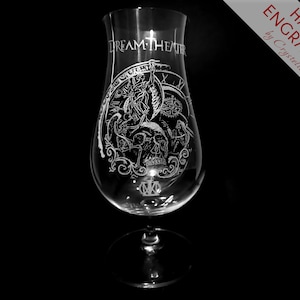 May include: A clear glass goblet with a hand-engraved design featuring a skull, wings, and the text "Dream Theater".