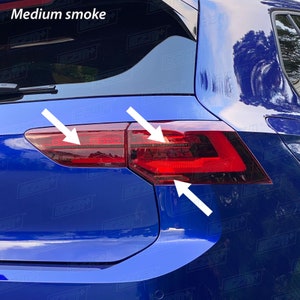 May include: A blue car with tinted rear lights. The rear lights are a medium smoke tint. The rear lights are on the back of the car.