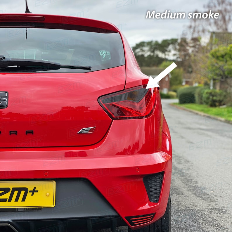 May include: A red car with a tinted taillight. The taillight is labeled "Medium smoke".