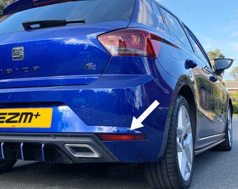 May include: Rear view of a blue car with a black bumper and a red reflector on the right side. The car has a black rear diffuser and a black spoiler.