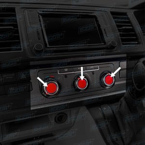 May include: Close-up of a car's dashboard featuring three red-centered control knobs with silver trim. The knobs are set against a black background, with white arrows indicating their function. The dashboard also includes a digital display and various buttons.