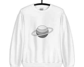 May include: White crewneck sweatshirt featuring a gray and white planet graphic with a ring. The planet design has three horizontal stripes in varying shades of gray. The sweatshirt is hanging on a black hanger.