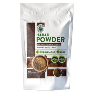 May include: A white bag with a brown powder inside. The bag has a label that says "Harad Powder" and "Haritaki (Terminalia Chebula)". The label also says "Net Weight: 200g / 7.05 oz." and "Herbal Supplement Caffeine Free". There are two round labels on the bag that say "100% Natural" and "100% Organic".