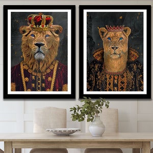May include: Two framed prints of lions wearing royal attire. The lion on the left is wearing a gold crown and a red and gold robe. The lion on the right is wearing a gold crown and a black and gold robe.