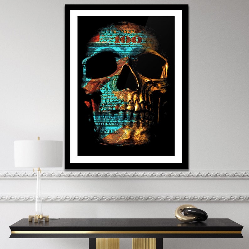 May include: A gold skull with a blue and green dollar bill pattern overlay. The skull is on a black background.