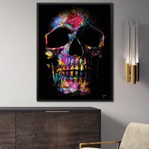 May include: A colorful skull with a black background. The skull is made up of a variety of geometric shapes and patterns in bright colors, including pink, blue, green, yellow, and purple.
