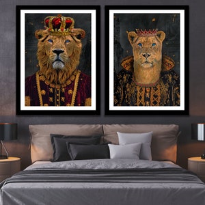 May include: Two framed portraits of lions wearing crowns and royal robes. The lion on the left is wearing a red robe with gold accents. The lion on the right is wearing a black robe with gold accents.