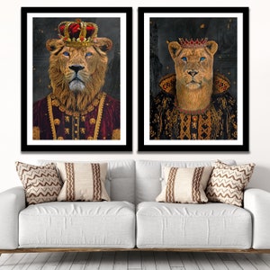 May include: Two framed prints of a lion and lioness wearing crowns and royal robes. The lion is wearing a red robe with gold accents and the lioness is wearing a black robe with gold accents.