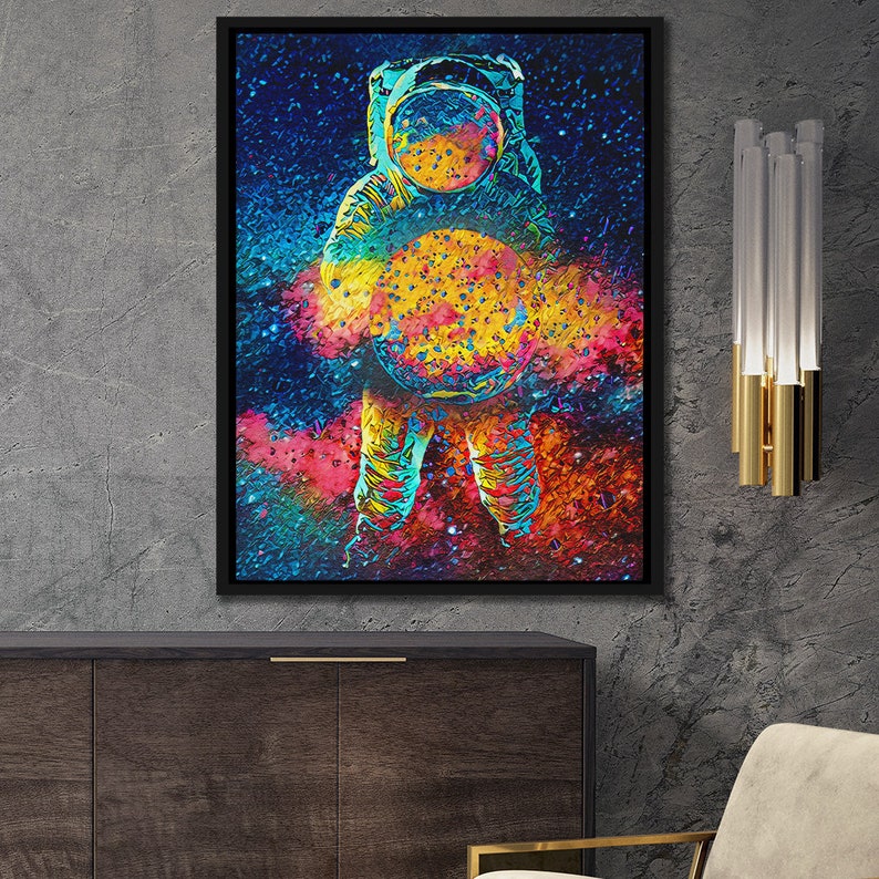 May include: A colorful abstract painting of an astronaut holding a planet in front of a galaxy background.